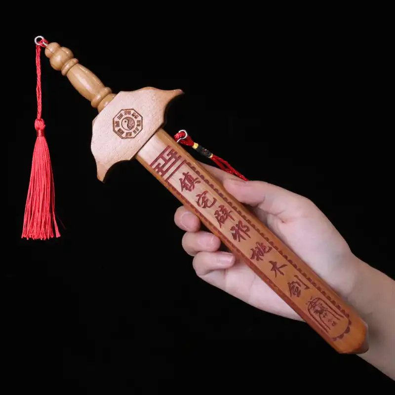 Multiple angle view of Chinese peach wood sword toy showing front, side and back perspectives.