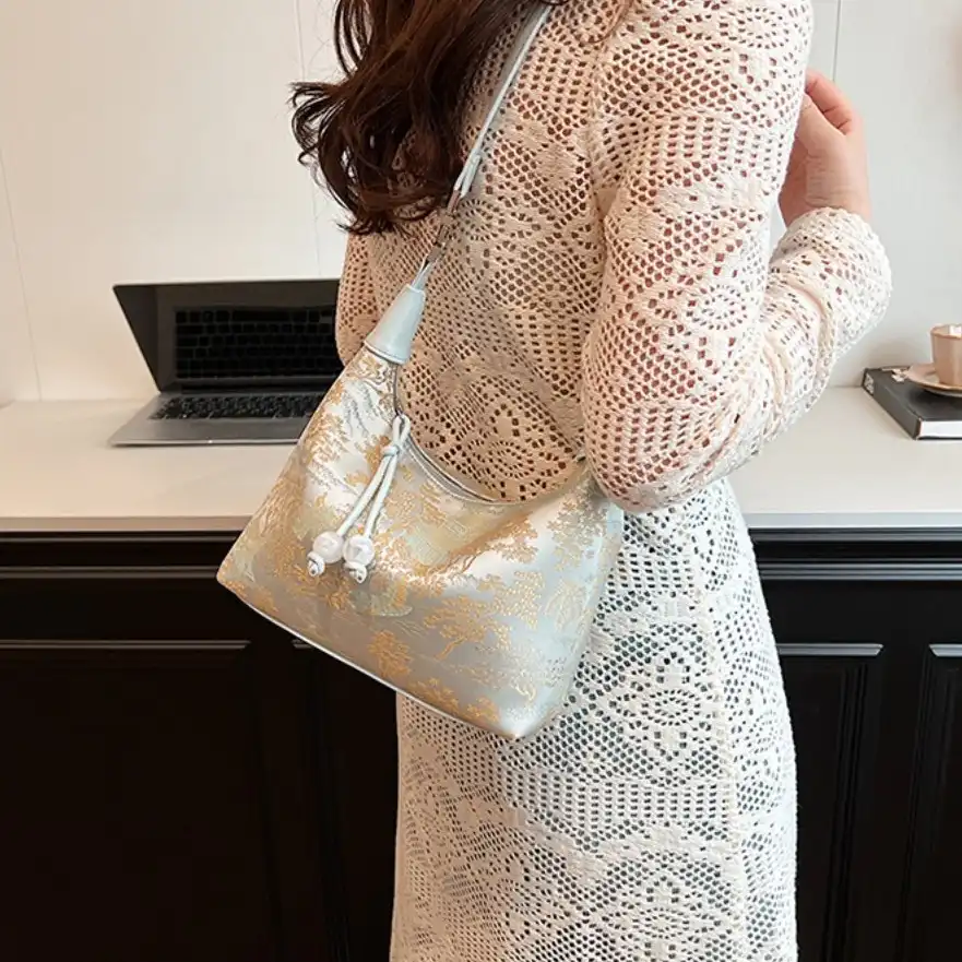 Chinese embroidered canvas tote bag with zipper in white showing intricate traditional patterns.