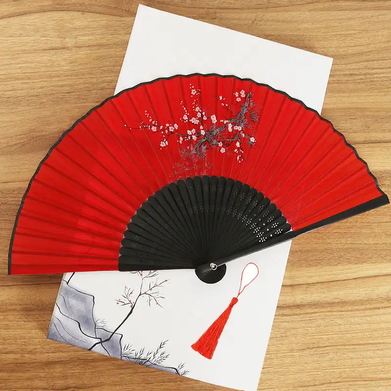 Chinese silk bamboo folding hand fan opened displaying printed design and 22 bamboo ribs.