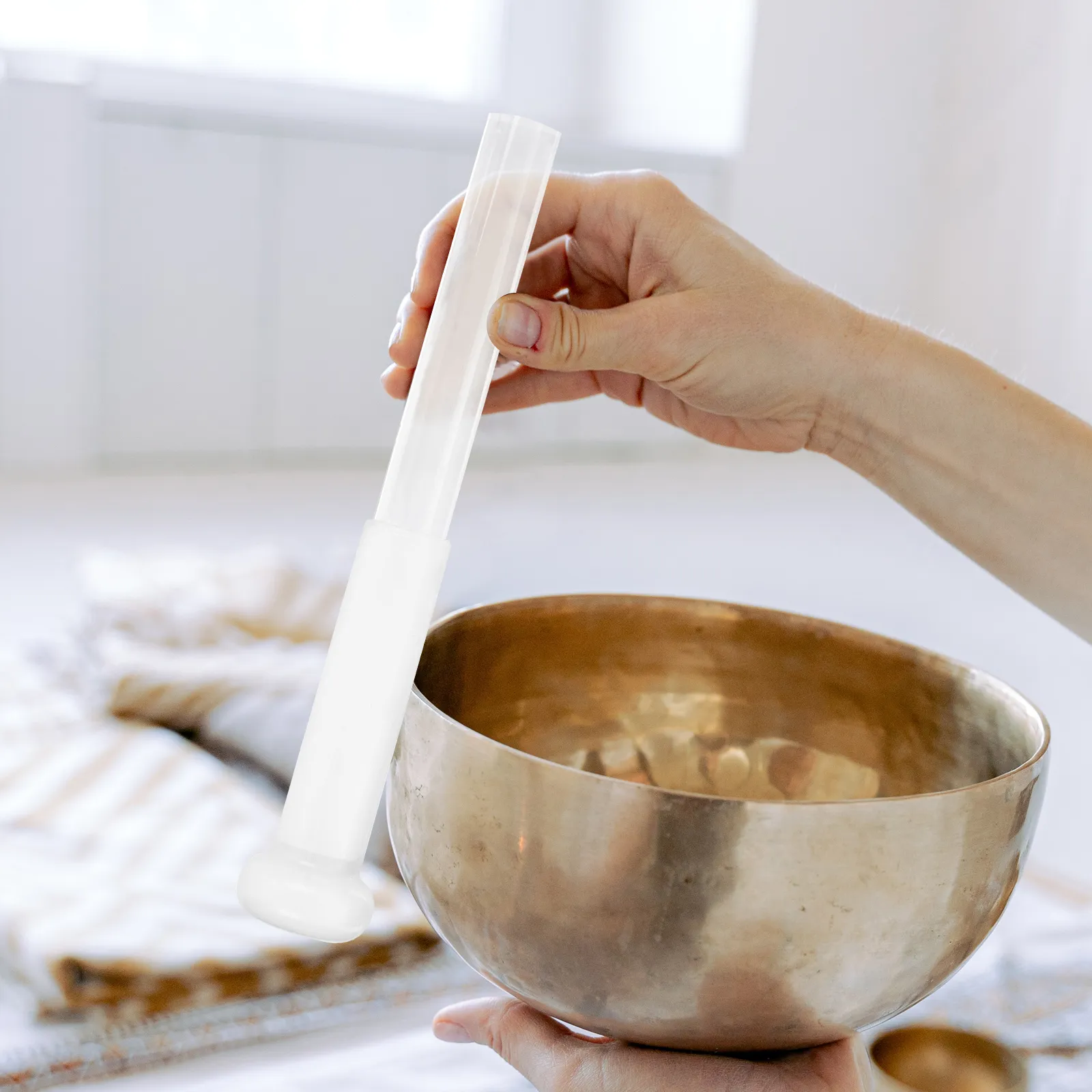 Transparent acrylic singing bowl mallet with crystal clear design for meditation and yoga practice.