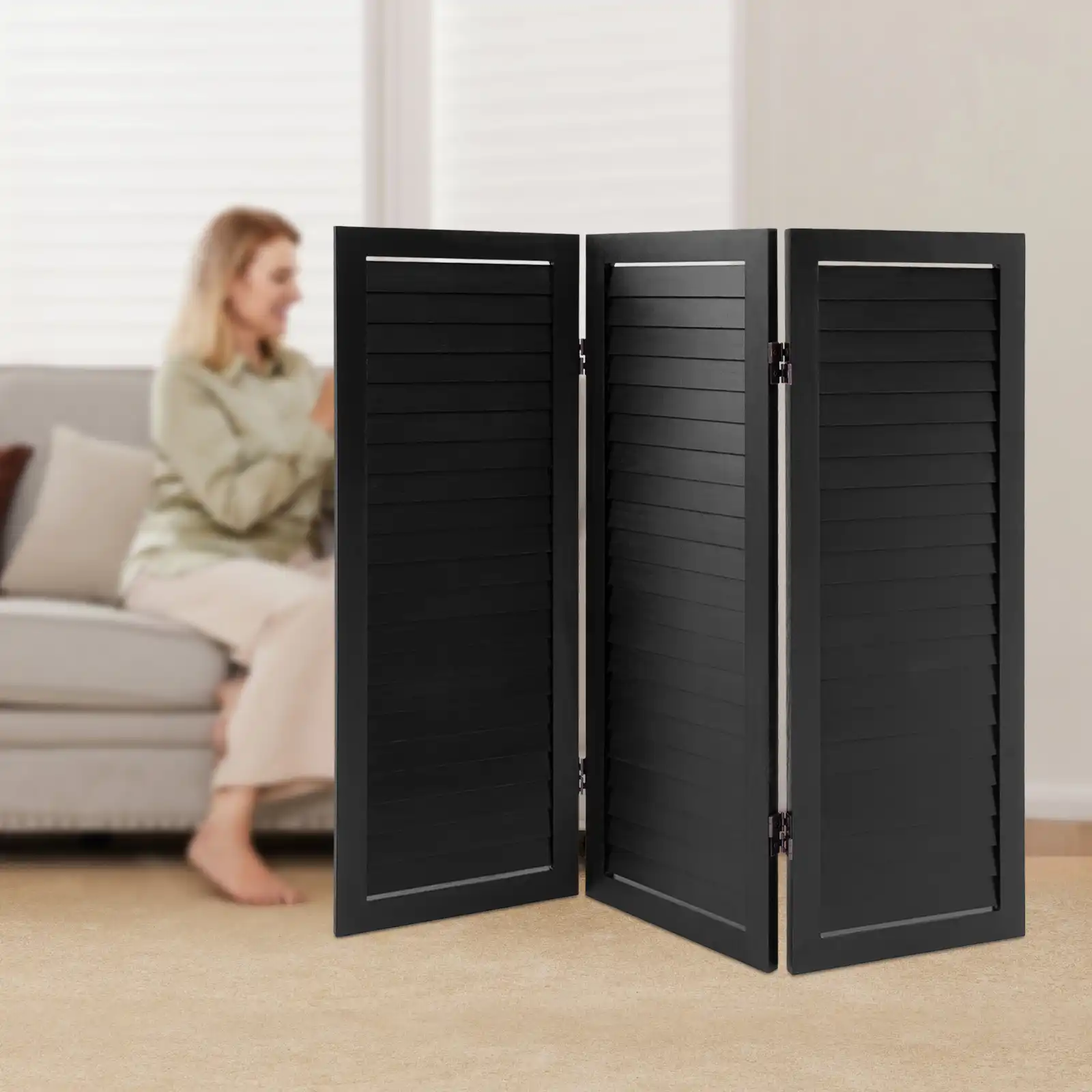 Black paulownia wood Chinese screen divider with 3-panel shutter design in modern living room.