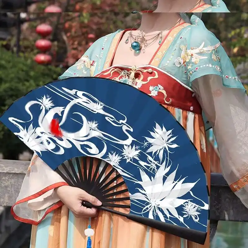 Chinese bamboo folding hand fan with cloth face displayed fully opened showing decorative pattern.