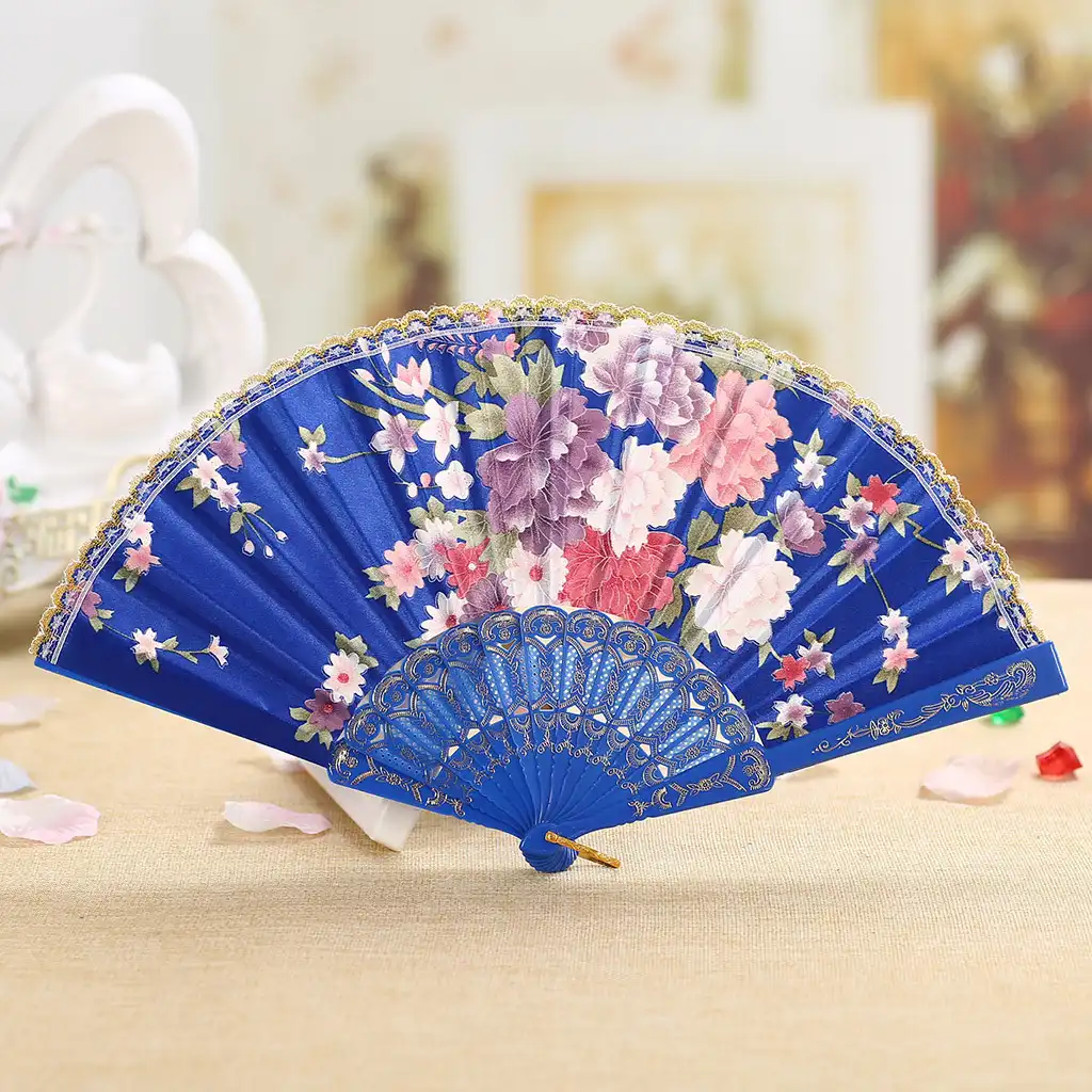 Japanese folding fan being used for cooling demonstration showing practical everyday functionality.
