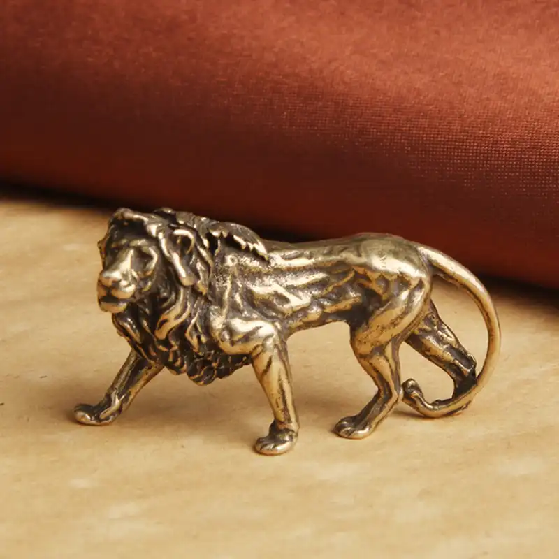Brass lion miniature with measuring ruler showing actual size dimensions for reference.