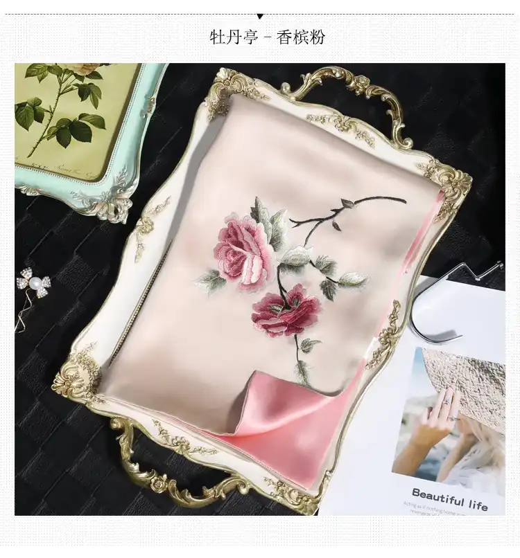 Traditional Suzhou embroidery technique demonstration showing delicate needlework on luxury silk fabric.