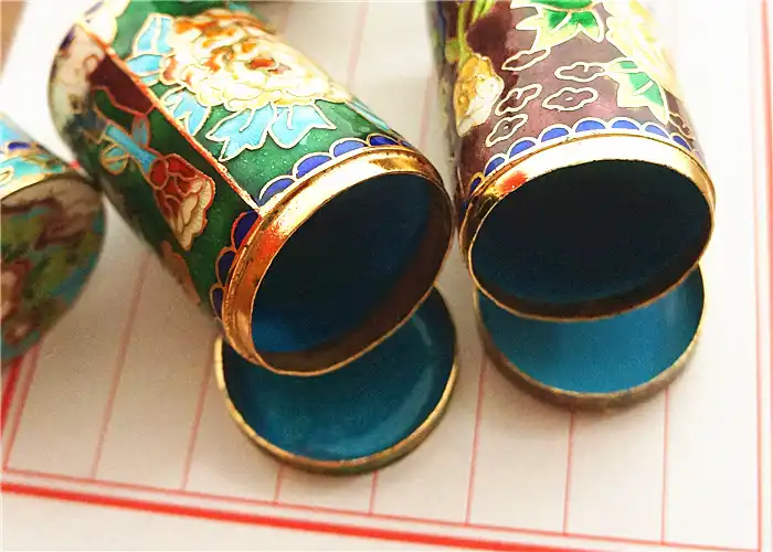 Detailed macro shot of cloisonne enamel surface texture and traditional wire compartments.