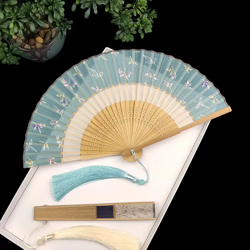 Professional dance performance using vintage folding fan as artistic prop and costume element.