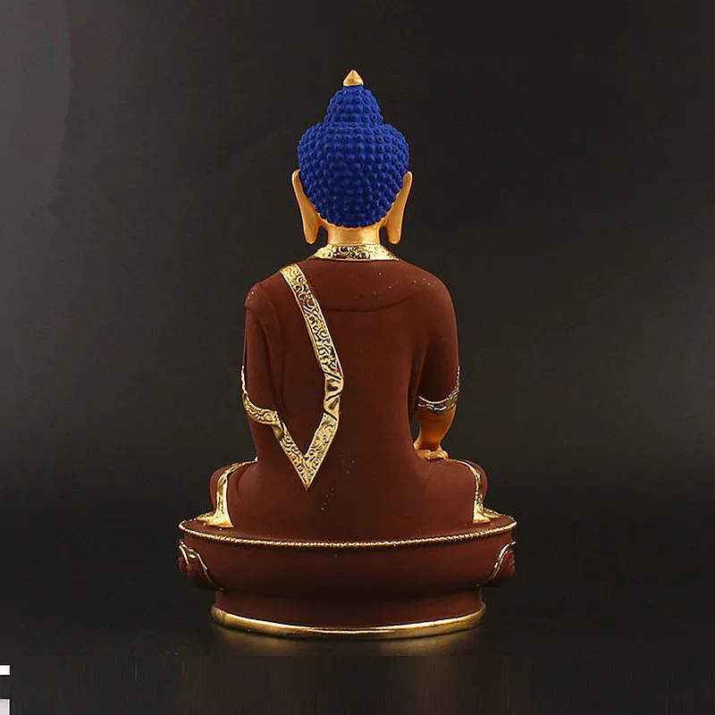 Buddha statue displayed on meditation altar with candles peaceful zen home setup inspiration.