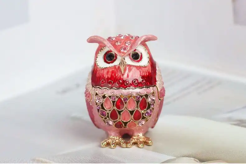 Close-up view of cloisonne owl box displaying intricate Seven Treasures enamel patterns and colors.