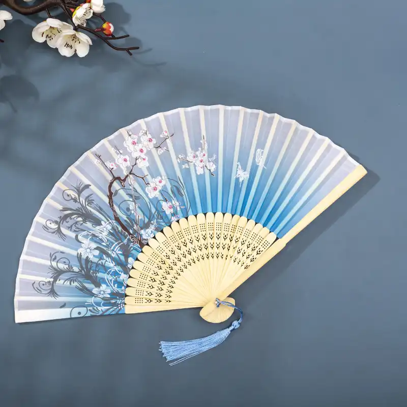 Party favor arrangement with multiple folding fans as elegant guest gifts.