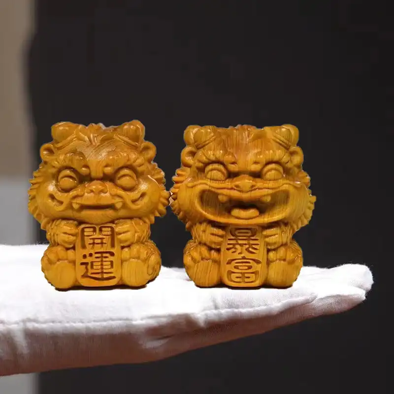 Top view of wooden foo dog statue pair showing traditional male and female guardian lion positioning.