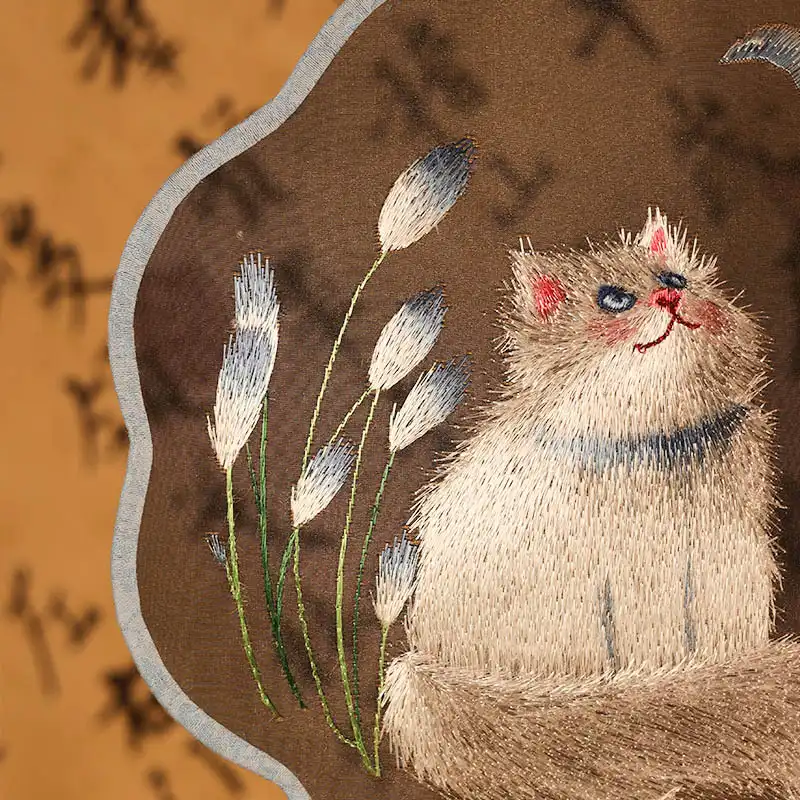 Close-up detail of intricate Suzhou embroidery silk surface showing delicate stitching and vibrant colors.