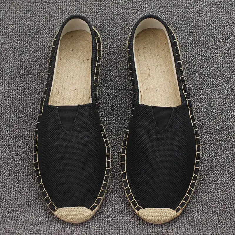Pair of vintage martial arts shoes on wooden floor displaying authentic Chinese craftsmanship.
