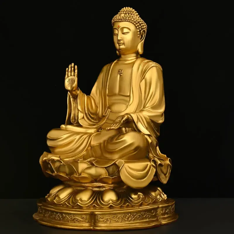 Buddha statue placed on modern living room coffee table with plants and books nearby.