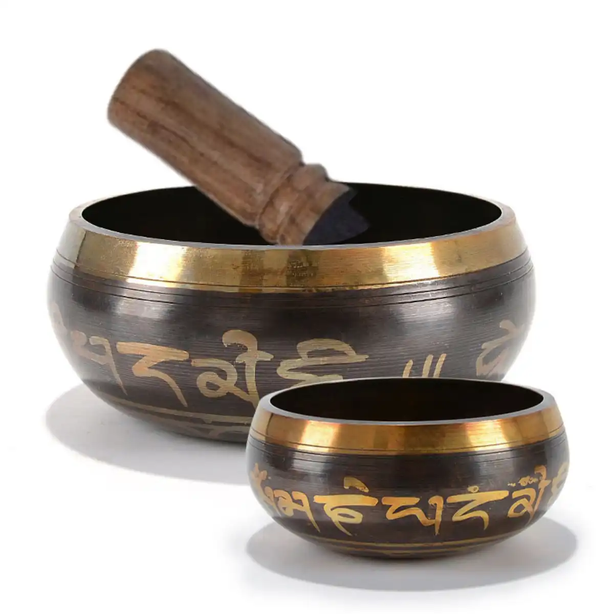 Professional meditation setup with singing bowl, candles, and yoga mat in serene environment.