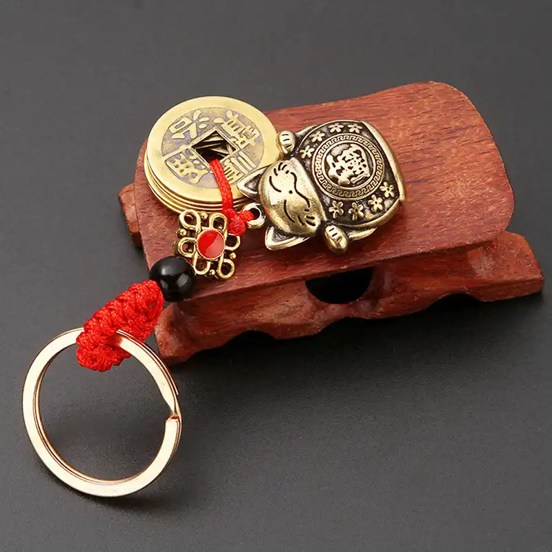 Feng shui keychain attached to car keys demonstrating practical daily use.
