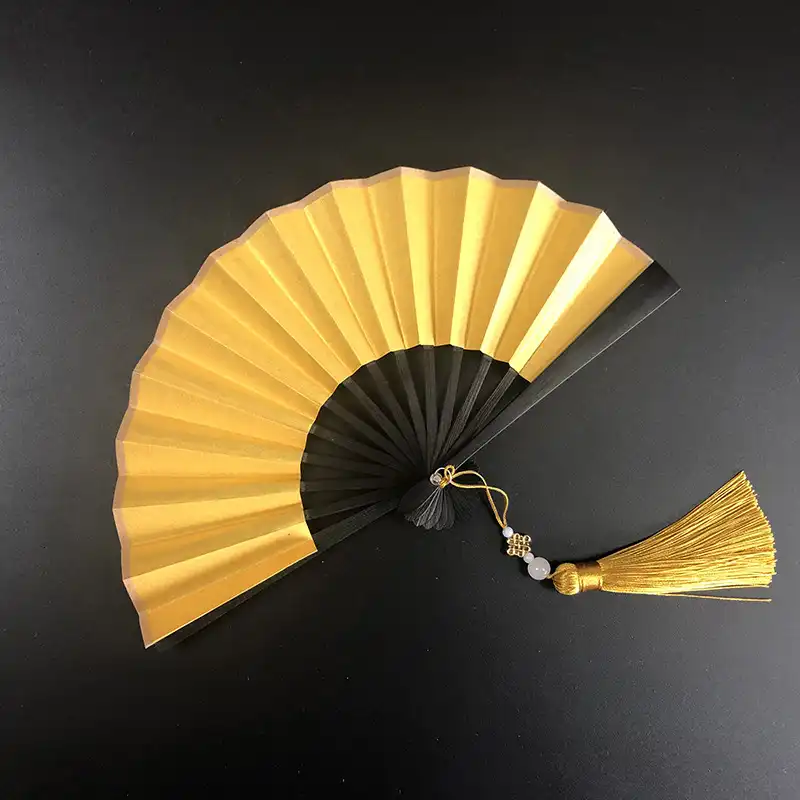Craft supplies arranged with blank paper fans ready for DIY decoration and customization activities.