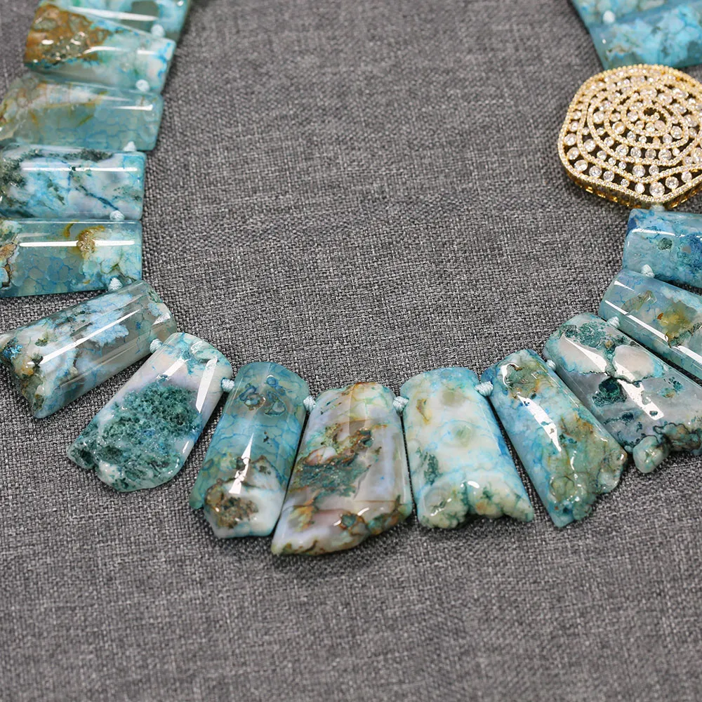 Close-up detail of blue agate stones showing natural patterns and high luster semi-precious gems.