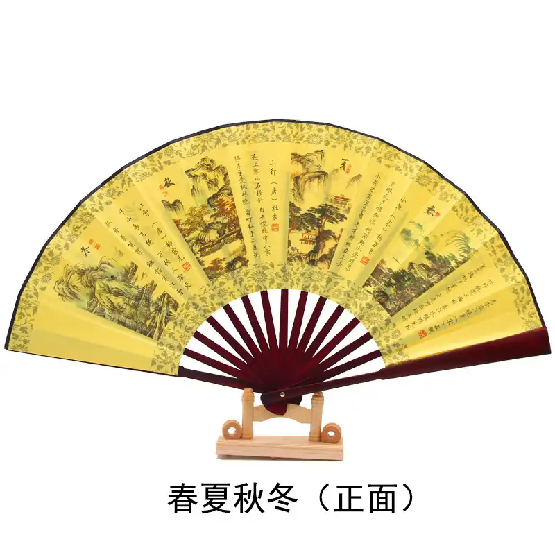 Traditional Chinese fan displayed on wooden surface highlighting ancient style aesthetic and cultural appeal.