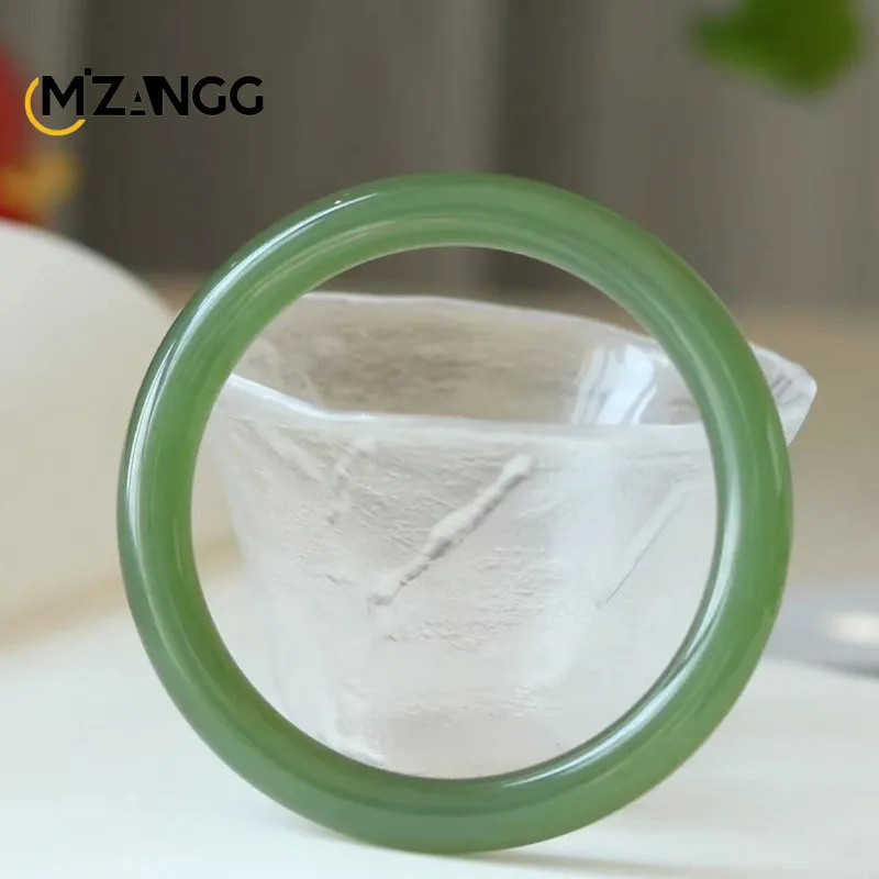 Hetian jade bracelet in duck egg green color showing natural Qinghai material texture and round bangle shape.