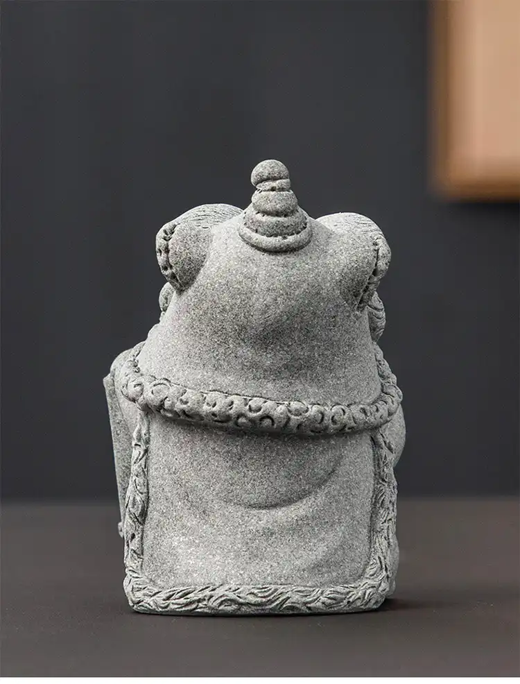 Handmade stone cat tea pet ornament with natural texture and feng shui design for tea ceremony.