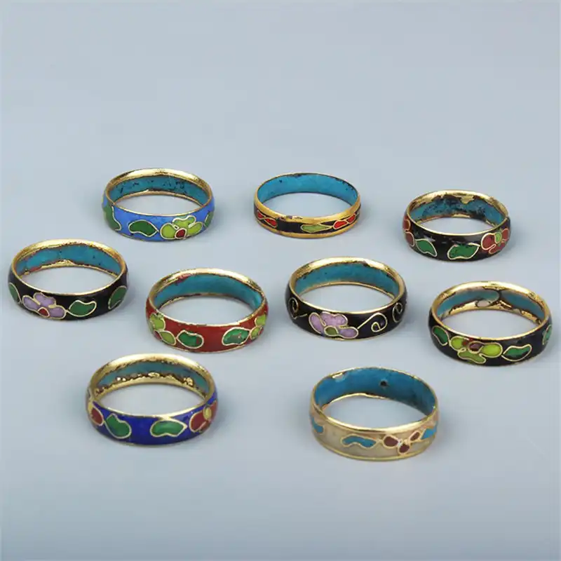Traditional cloisonne copper rings with colorful enamel patterns showcasing Beijing craftsmanship.
