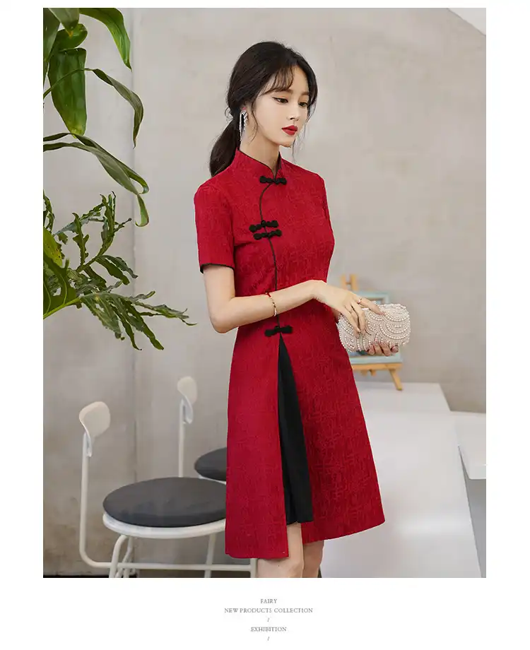 Model wearing vintage cheongsam in professional setting demonstrating office appropriate style.