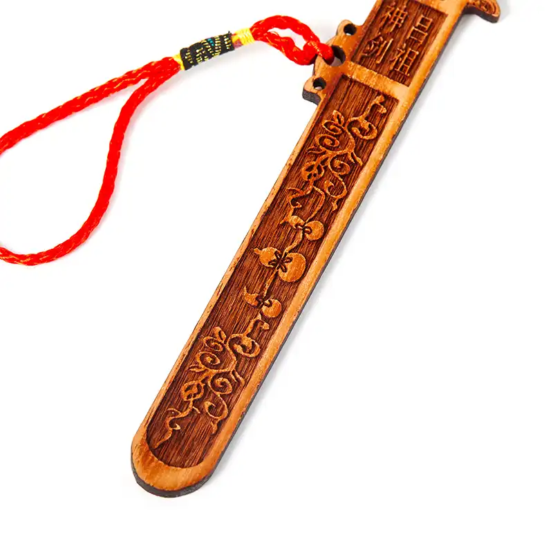 Full length view of 18.2cm Tai Chi peach wood sword displaying natural wood grain and carved symbols.