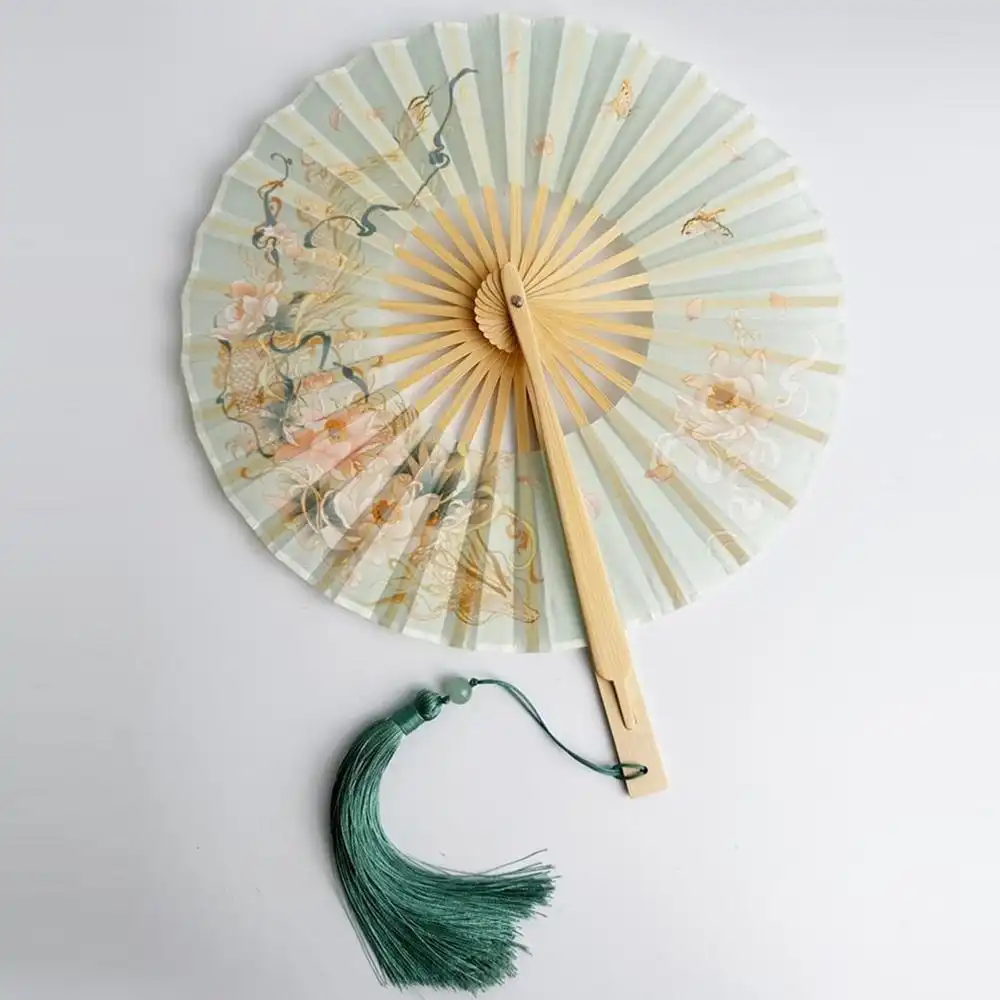 Outdoor event usage of round fan for practical cooling and style accessory.