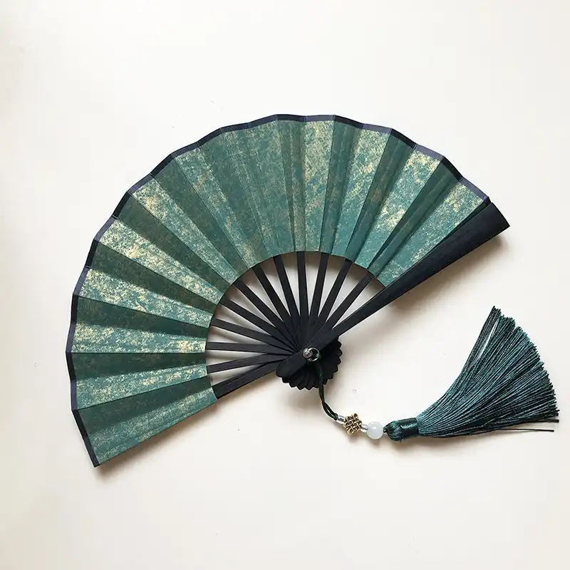 Wedding party guests holding personalized decorated paper fans as memorable keepsake favors.