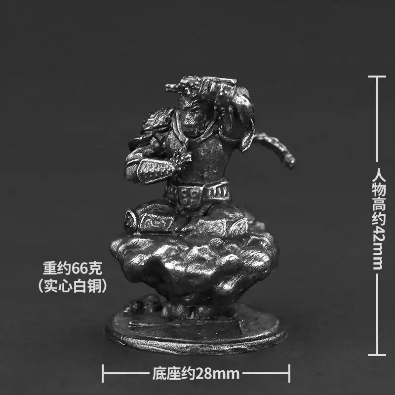 Close-up view of Sun Wukong character details on metal miniature ornament with intricate features.