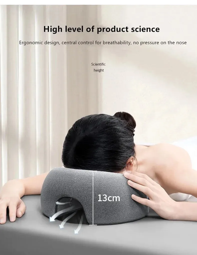 Ergonomic memory foam face down cervical pillow with breathable cover on white background.