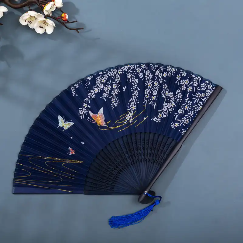 Closed folding fan showing compact 21cm portable size and bamboo frame construction quality.