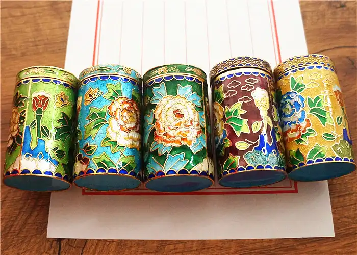 Close-up view of cloisonne toothpick holder showing intricate enamel patterns and color details.