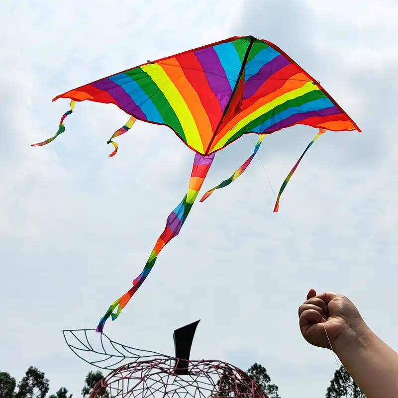 Adult hands holding kite handle and line demonstrating easy control and comfortable grip.