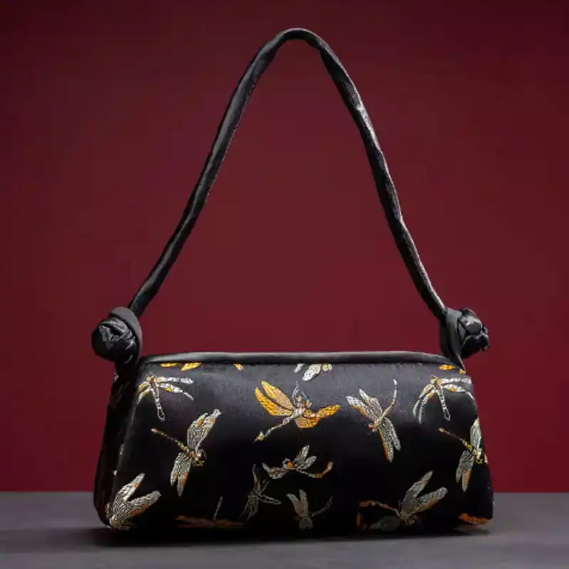 Yellow silk embroidered women bag showcasing vibrant colored thread embroidery patterns.