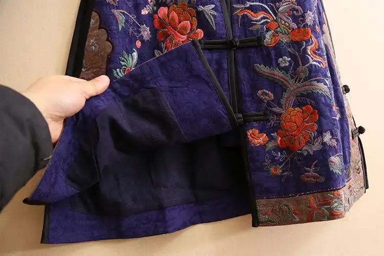 Floral embroidery pattern close-up showcasing intricate stitching and color details.