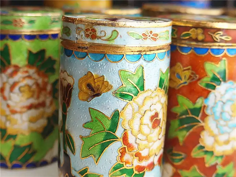 Elegant table setting featuring cloisonne toothpick holder as decorative dining accessory.