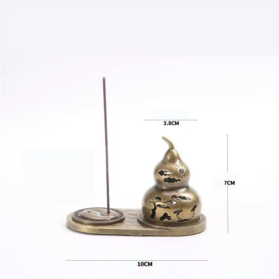 Feng shui gourd incense burner in use with burning incense stick creating peaceful meditation atmosphere.