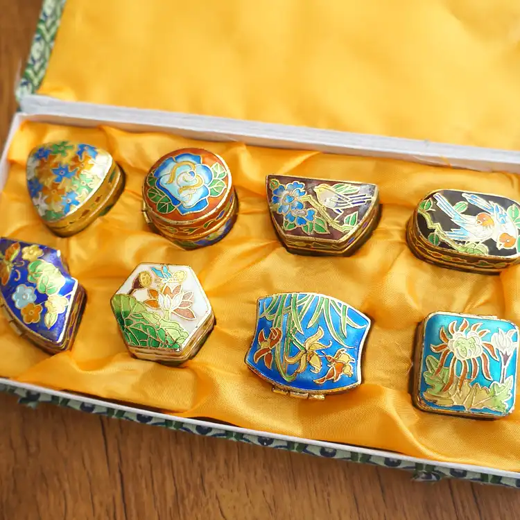 Collection of miniature cloisonne boxes showing size variations and different enamel patterns.