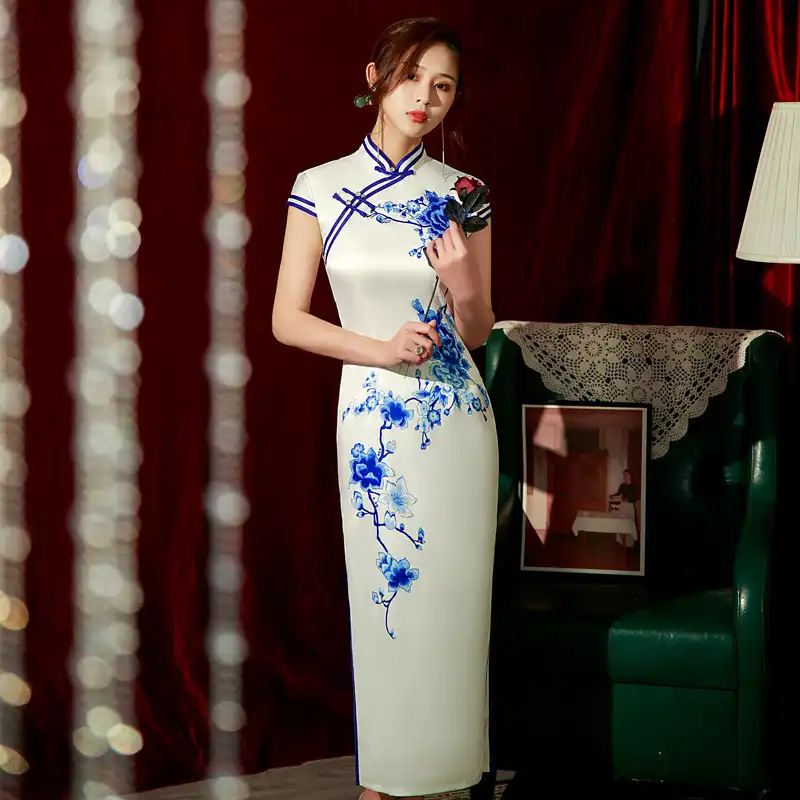 Model wearing cheongsam dress in formal setting demonstrating elegant posture and graceful movement.