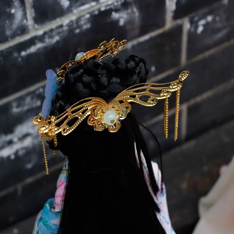 Detailed view of ornate headwear and facial features on Chinese princess ball jointed doll collectible.