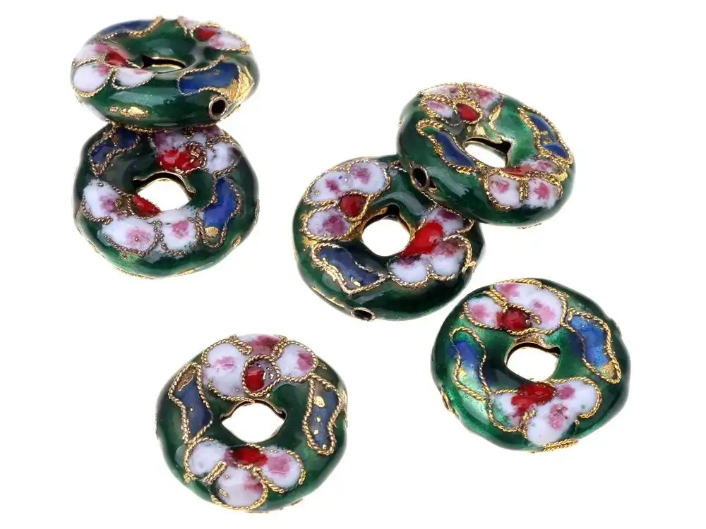 Close examination of cloisonne bead hole quality ensuring smooth jewelry wire threading.