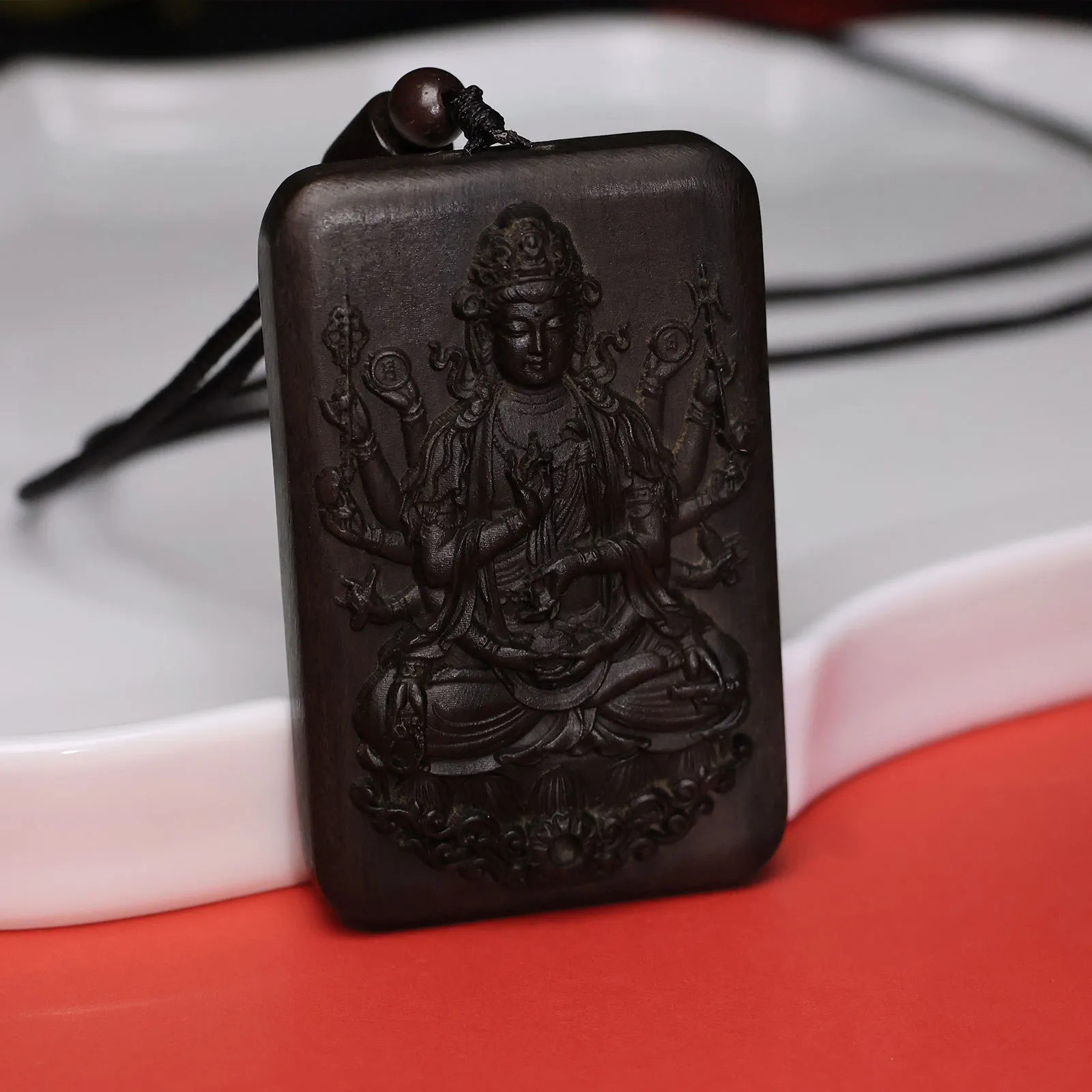 Person wearing agarwood Guanyin pendant necklace for spiritual protection and meditation.
