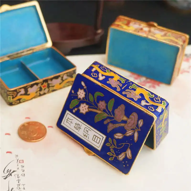 Vintage cloisonne box collection arranged to show various shapes and decorative styles.