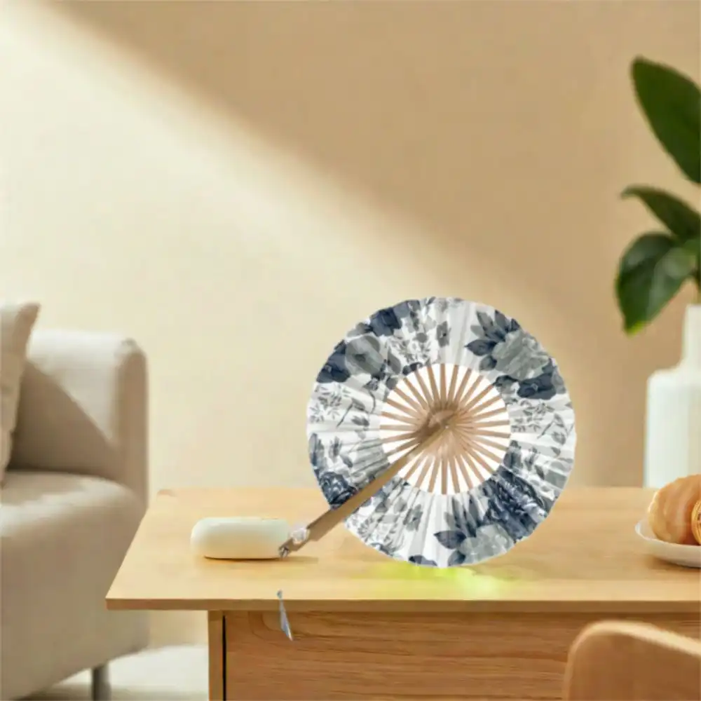Back side of round fan showing complementary windmill motifs and elegant cultural artistic details.
