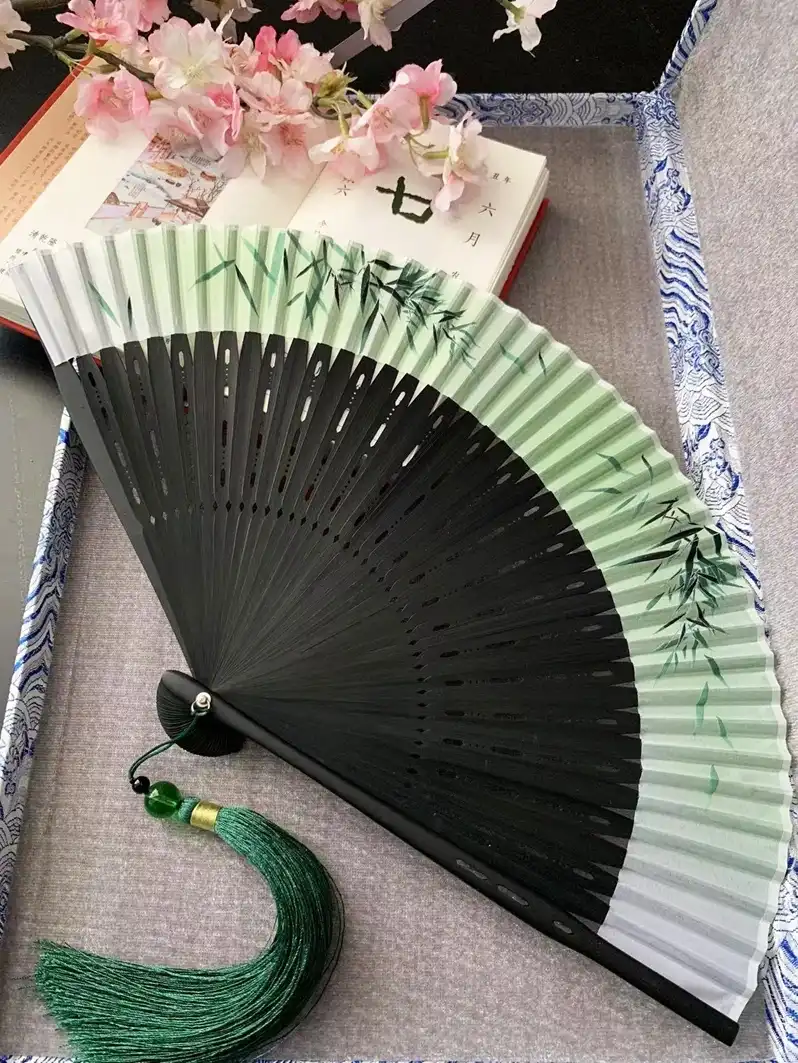 Cheongsam outfit styling with ancient style bamboo fan as elegant cultural accessory.