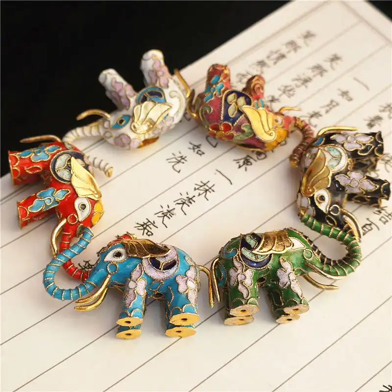 Multiple angle view of cloisonne elephant demonstrating three-dimensional enamel work.