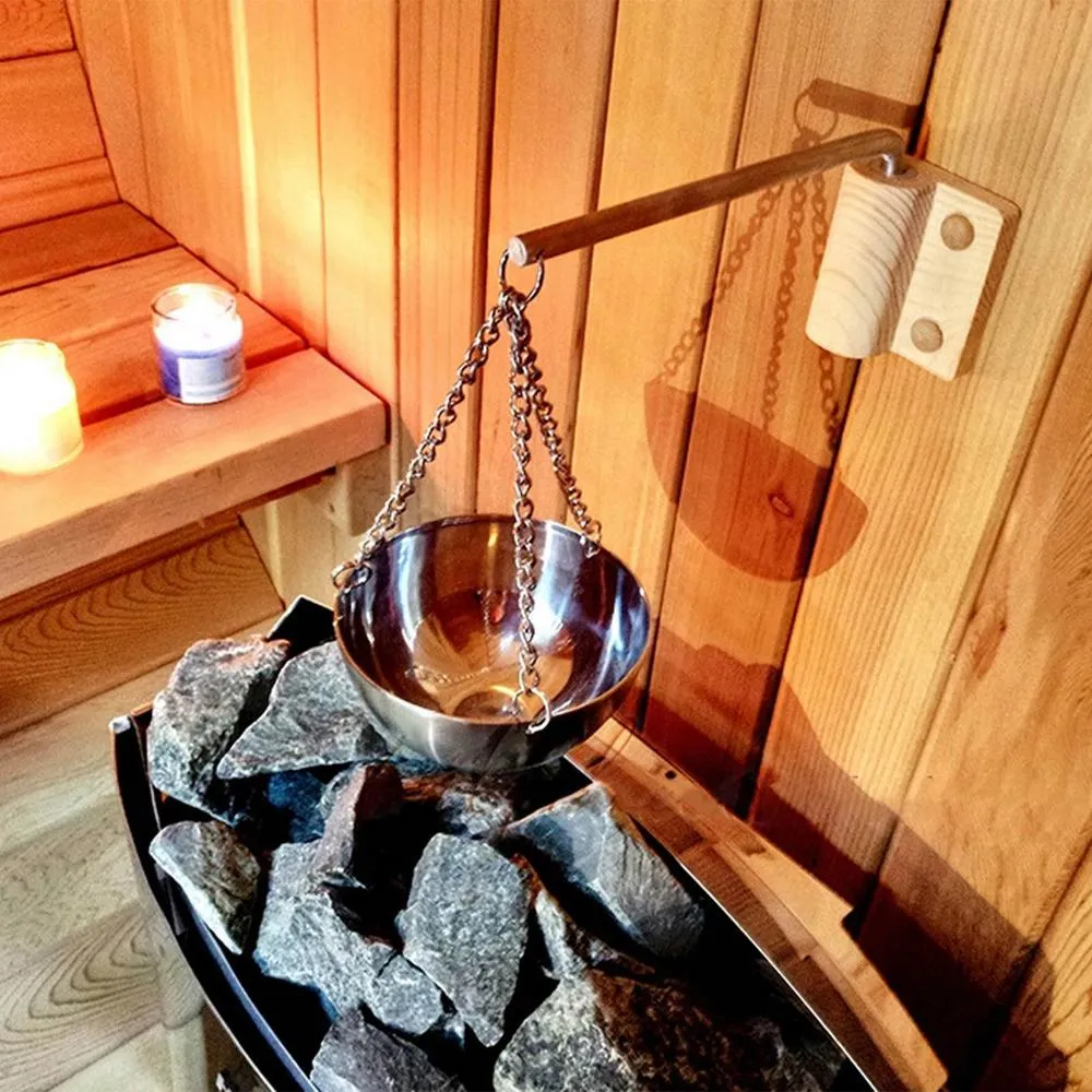 Close-up of 12cm diameter stainless steel aromatherapy bowl with essential oils for sauna use.