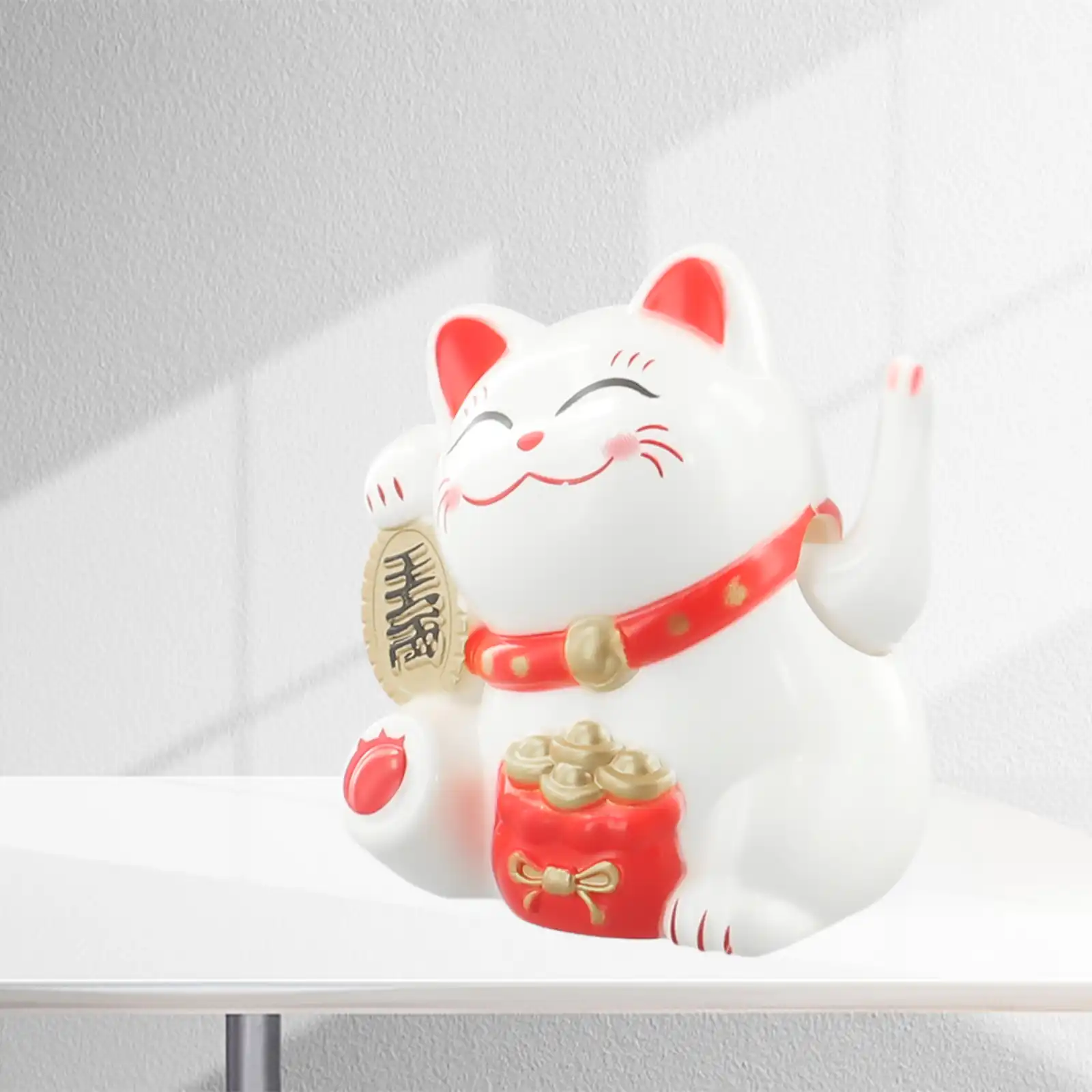 Close-up view of solar powered lucky cat waving paw mechanism in action.